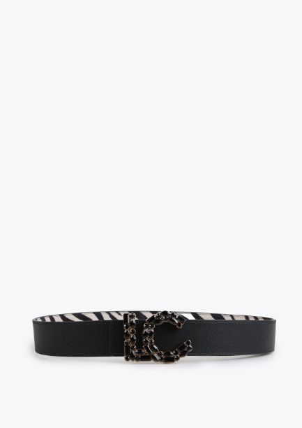 Cinturón reversible con estampado animal print byn, reverso en negro, hebilla LC con cristales en negro, de Lola Casademunt